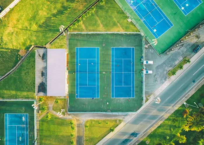 an aerial view of a tennis court in a park