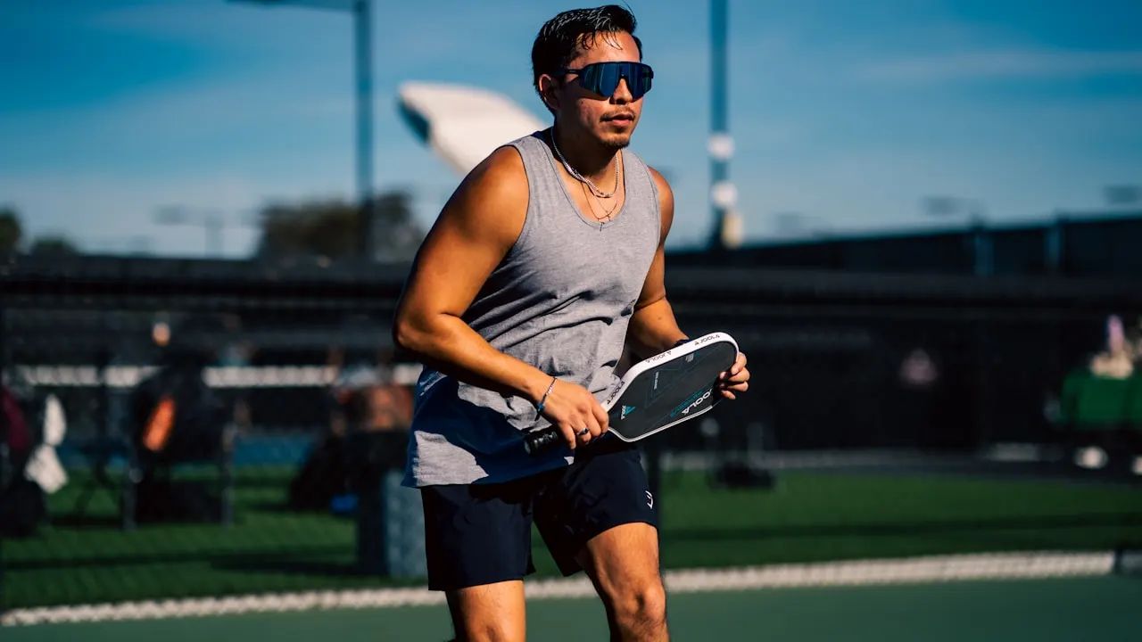 A man holding a tennis racquet on a tennis court